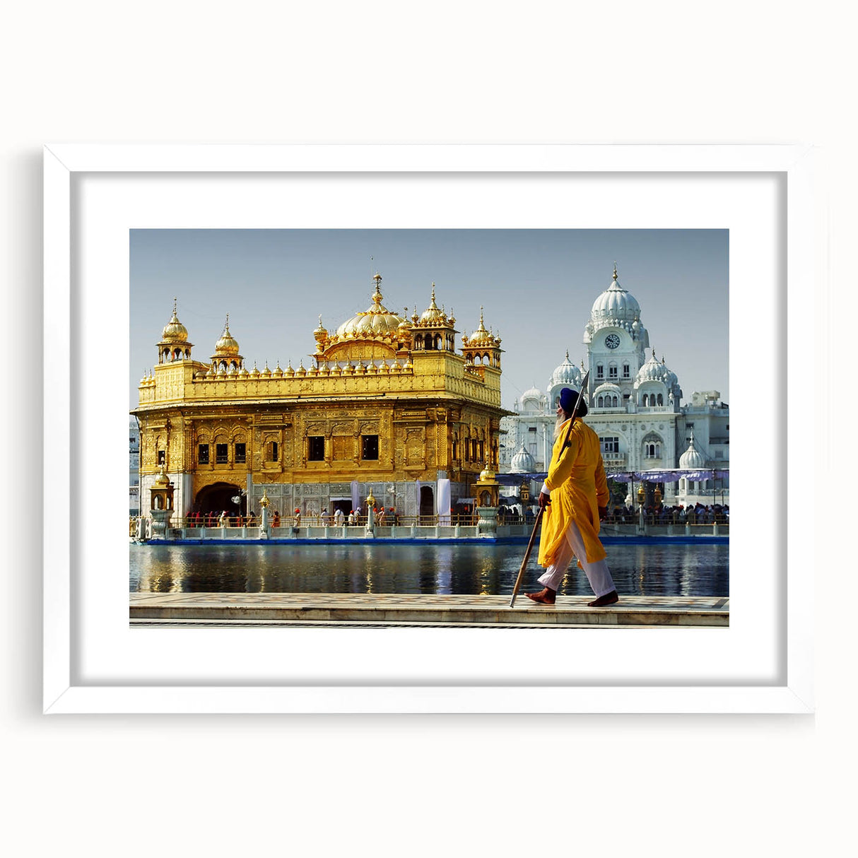 Abstract art print depicting a colorful Indian landscape on a white framed canvas, suitable for bedroom or dining room decor.