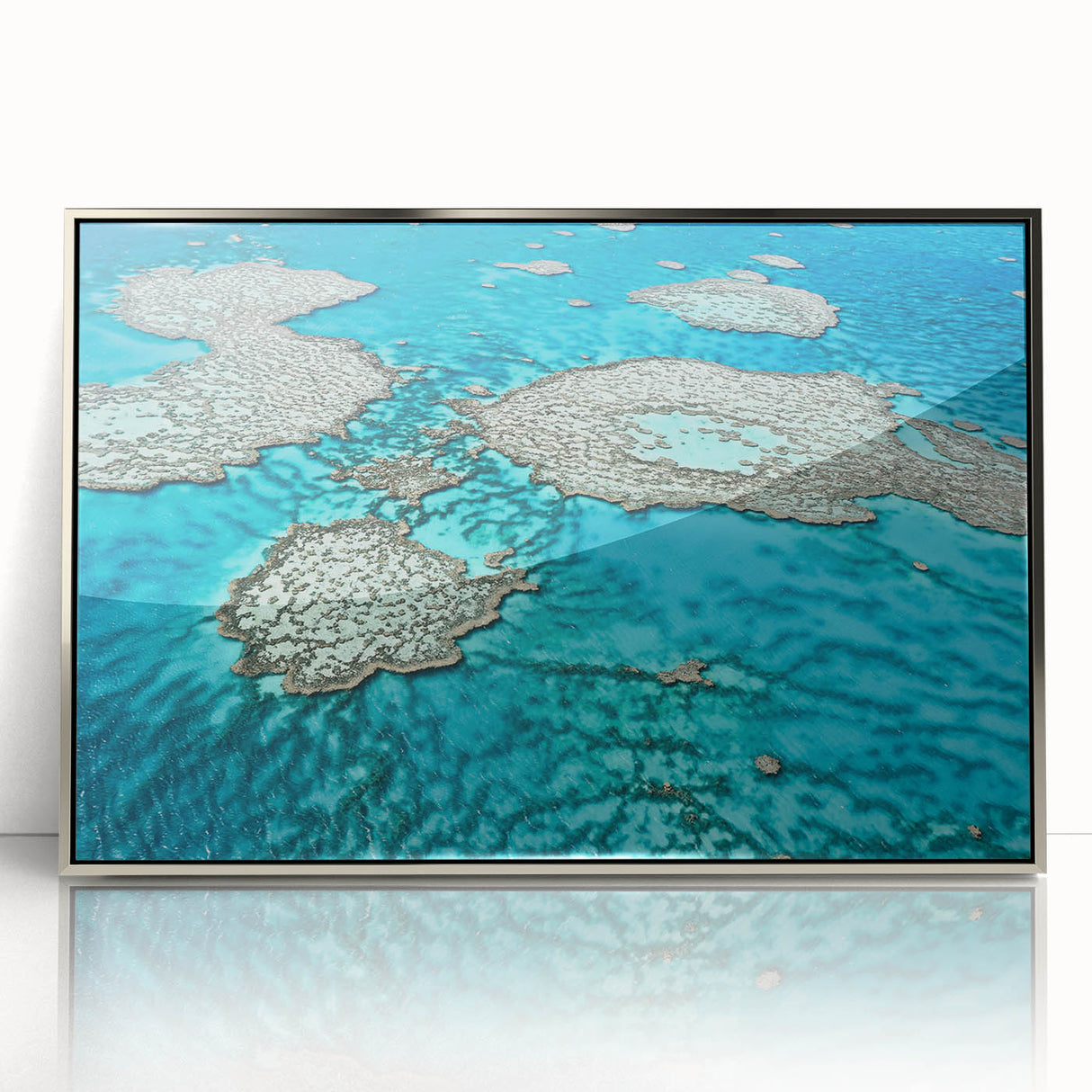 Acrylic print of the Great Barrier Reef in pastel shades, framed in silver, suitable for modern nursery decor.