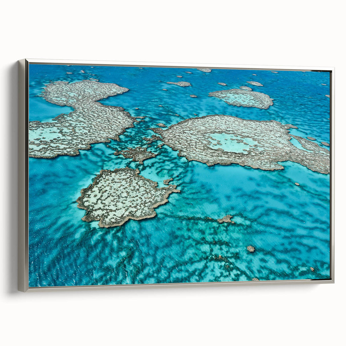 Vintage poster art of the Great Barrier Reef on a framed canvas, featuring vibrant marine colors.