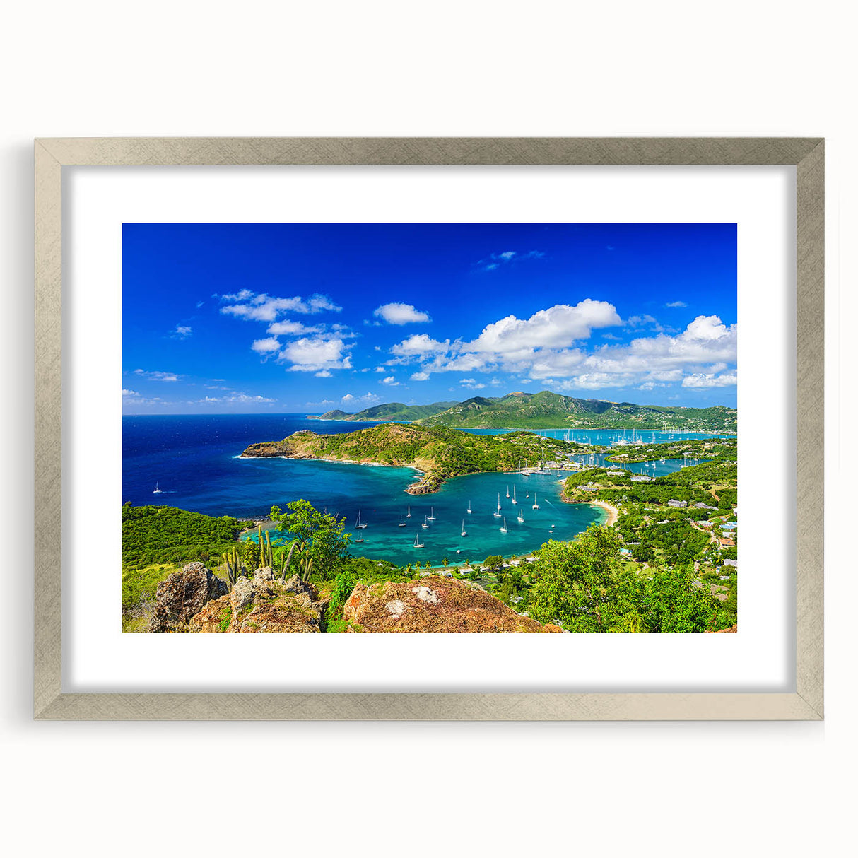 Abstract art print of Caribbean scenery in muted blue and green tones, framed in silver, ideal for living room decor.