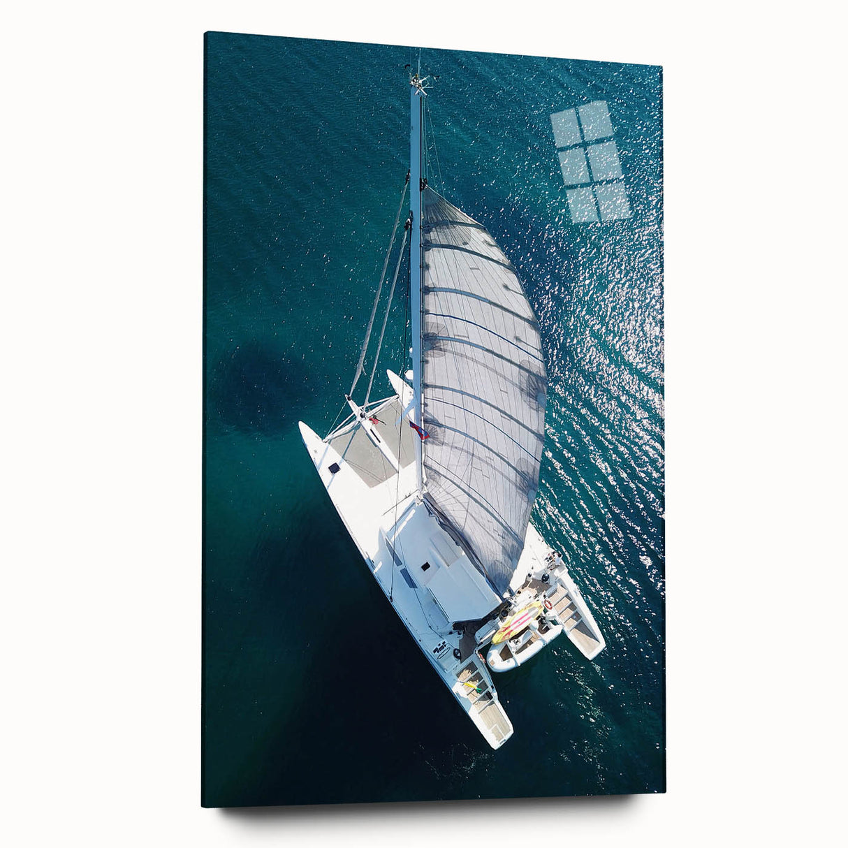 Large abstract wall art of a Caribbean seascape in blue and turquoise tones on acrylic glass.