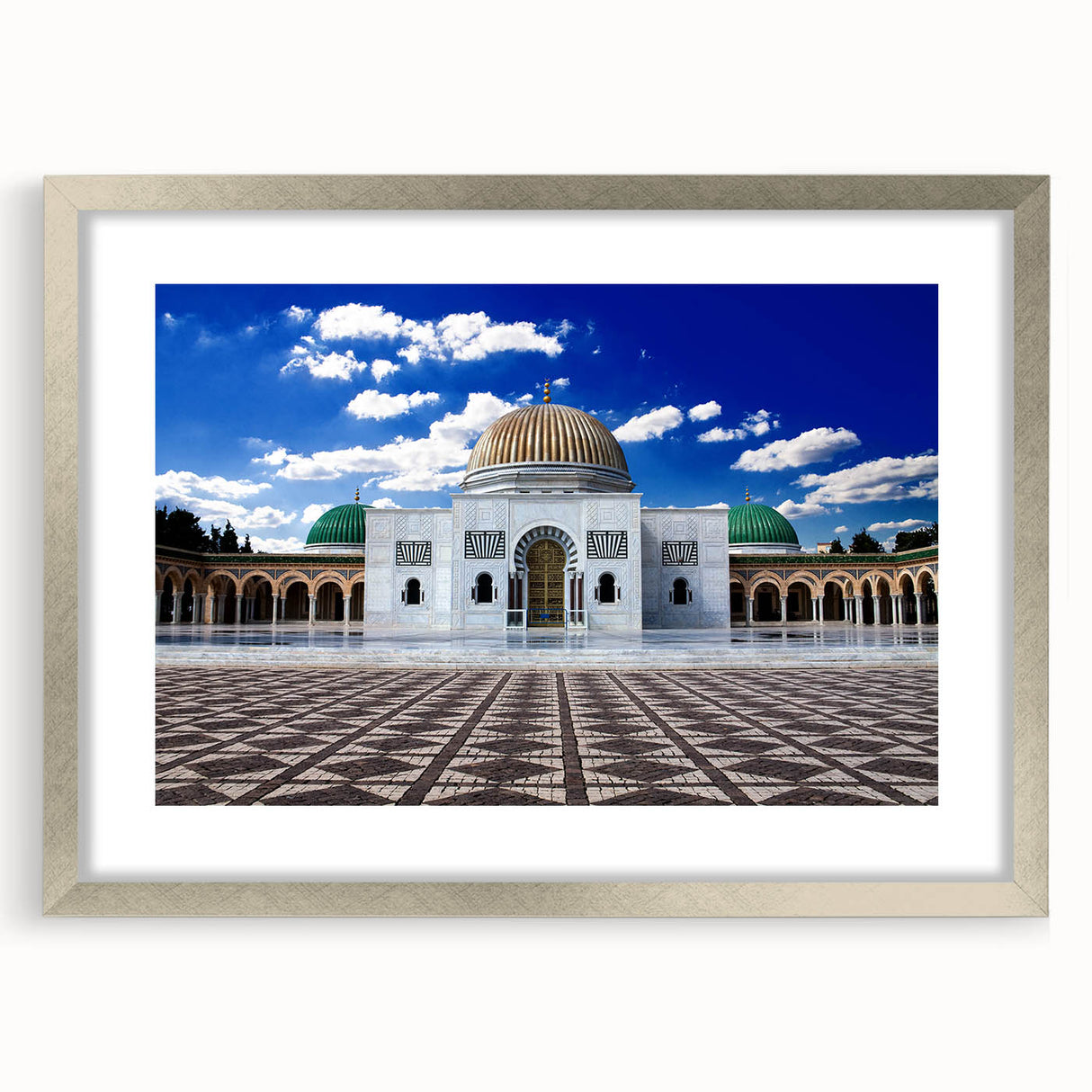 Textured abstract art print depicting a Tunisian landscape in earth tones, framed in silver, suitable for bedroom decor.