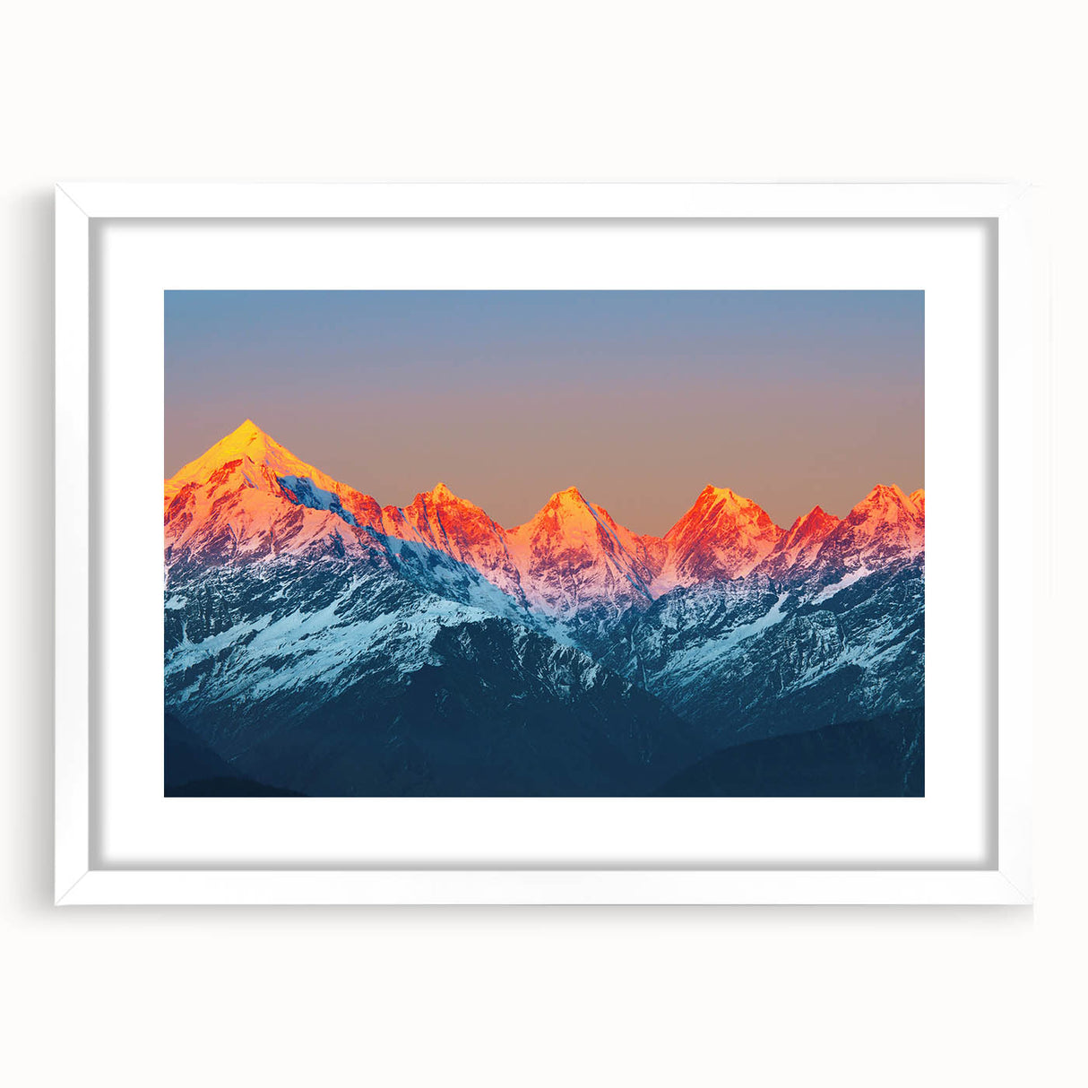 Abstract art print of a stylized Indian landscape in vibrant orange and red tones on a white framed canvas.