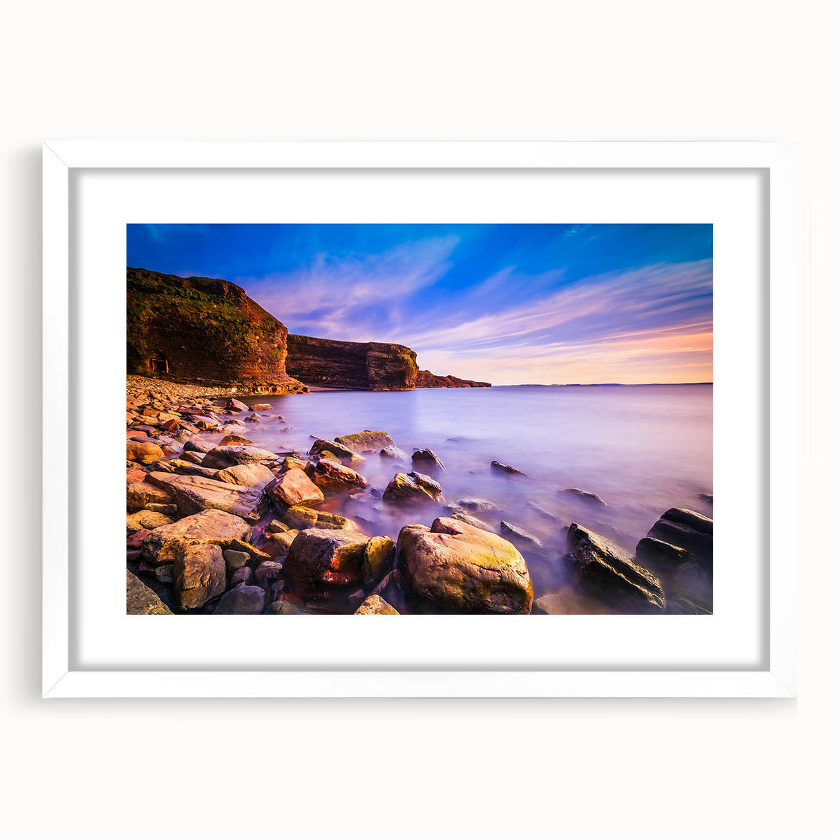 White-framed wall art of Newfoundland scenery in muted earth tones, ideal for dining room decor.