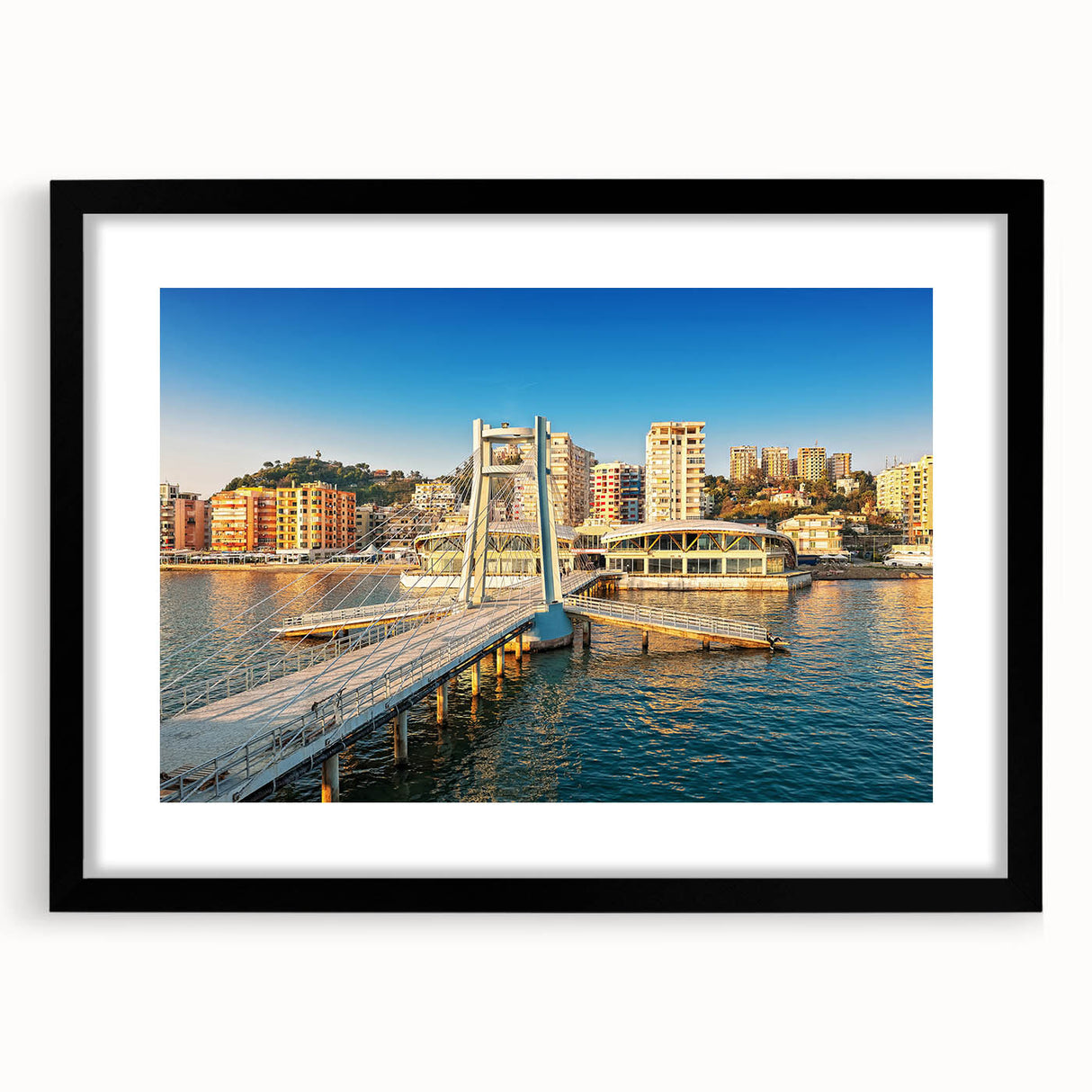 Abstract art print featuring vibrant, colorful textures of a European scenery, framed in black, ideal for living room decor.