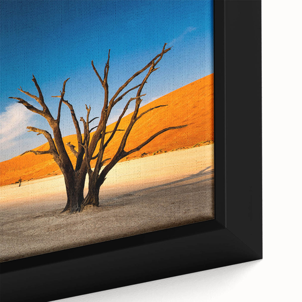 Close-up of a textured black wall art depicting the Namibian landscape on a framed canvas, featuring vibrant earthy tones.