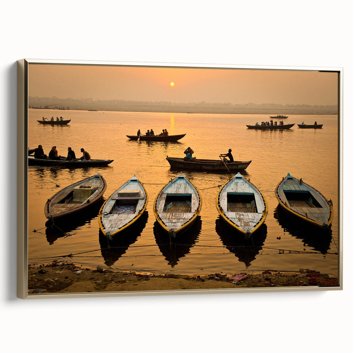 Framed canvas featuring a vintage-style landscape painting of an Indian scenery in muted gold and black tones.