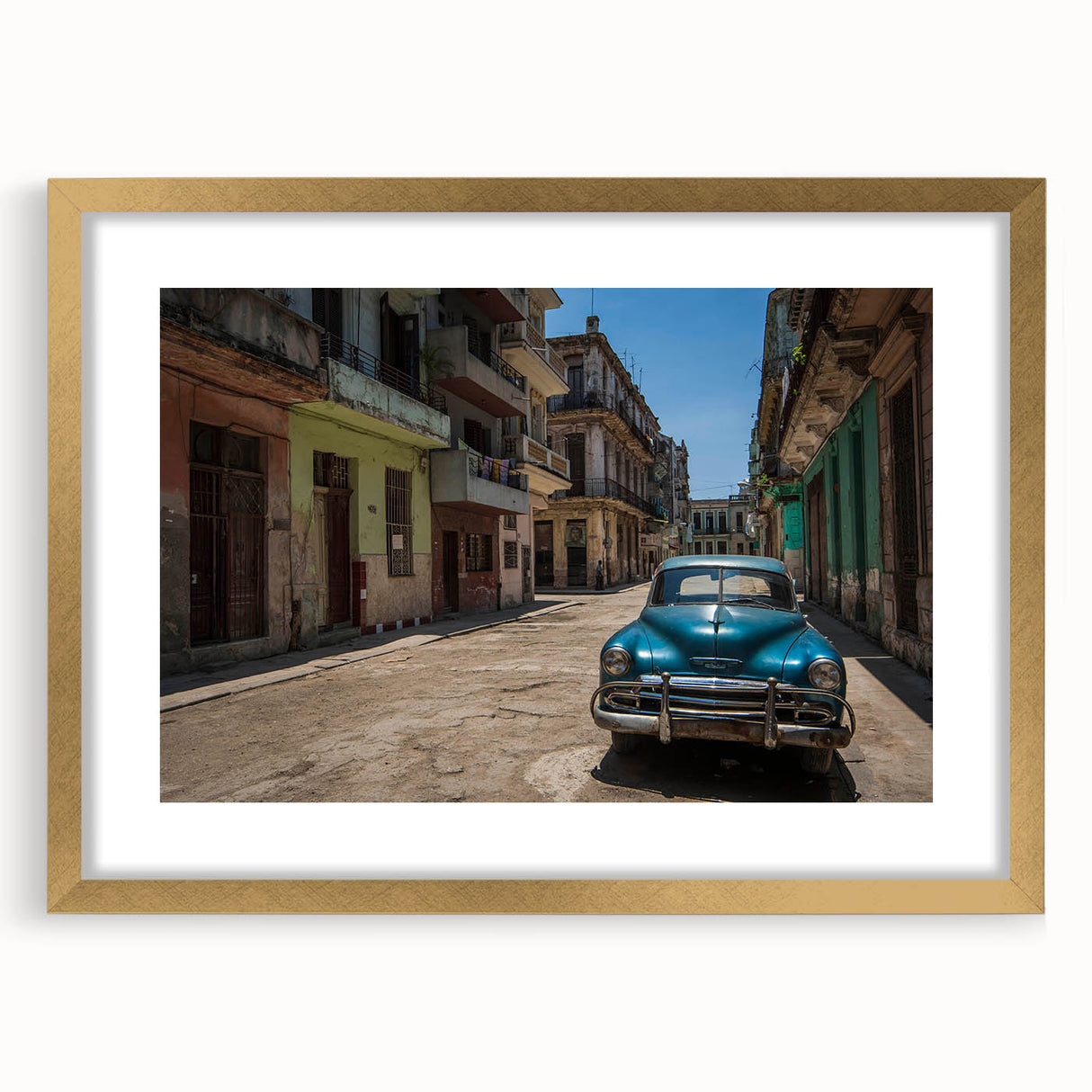 Abstract art print of a Caribbean scene in muted blue and green tones, framed in gold, ideal for dining room decor.