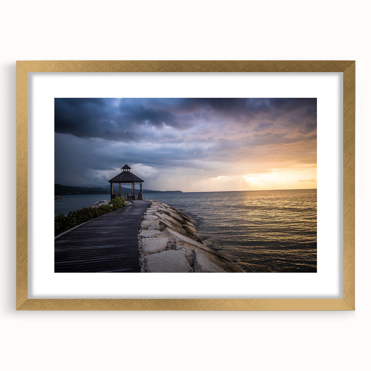 Abstract art print of a Caribbean scenery in vibrant blue and green, framed in gold, suitable for dining room decor.