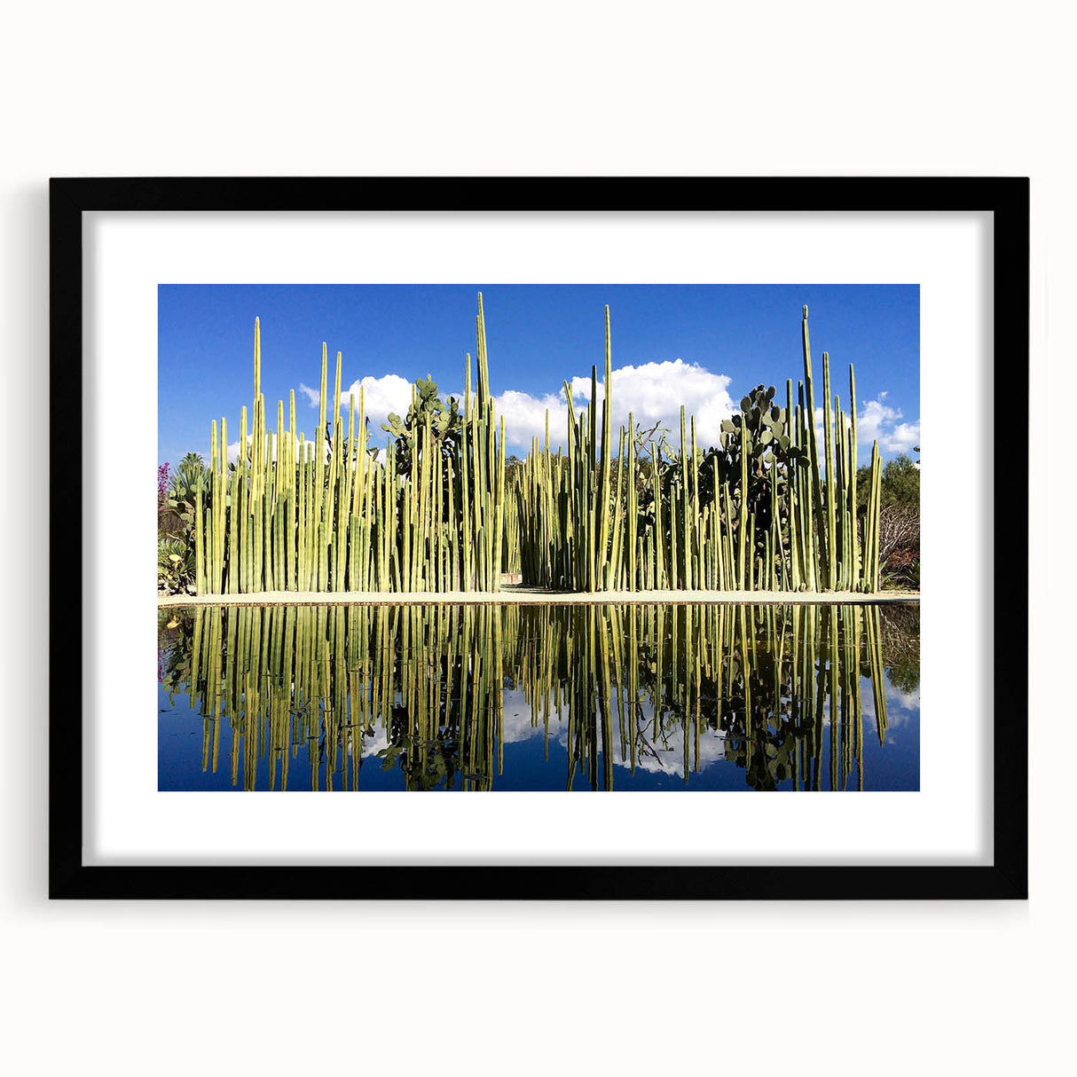 Extra large abstract art print depicting a colorful, textured scenery of Oaxaca, in a black frame with mat.