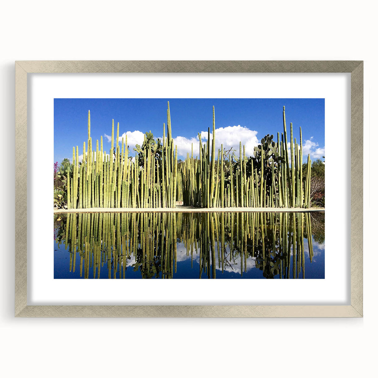 Textured abstract art print of Oaxaca scenery in muted earth tones, framed in silver, suitable for bedroom decor.