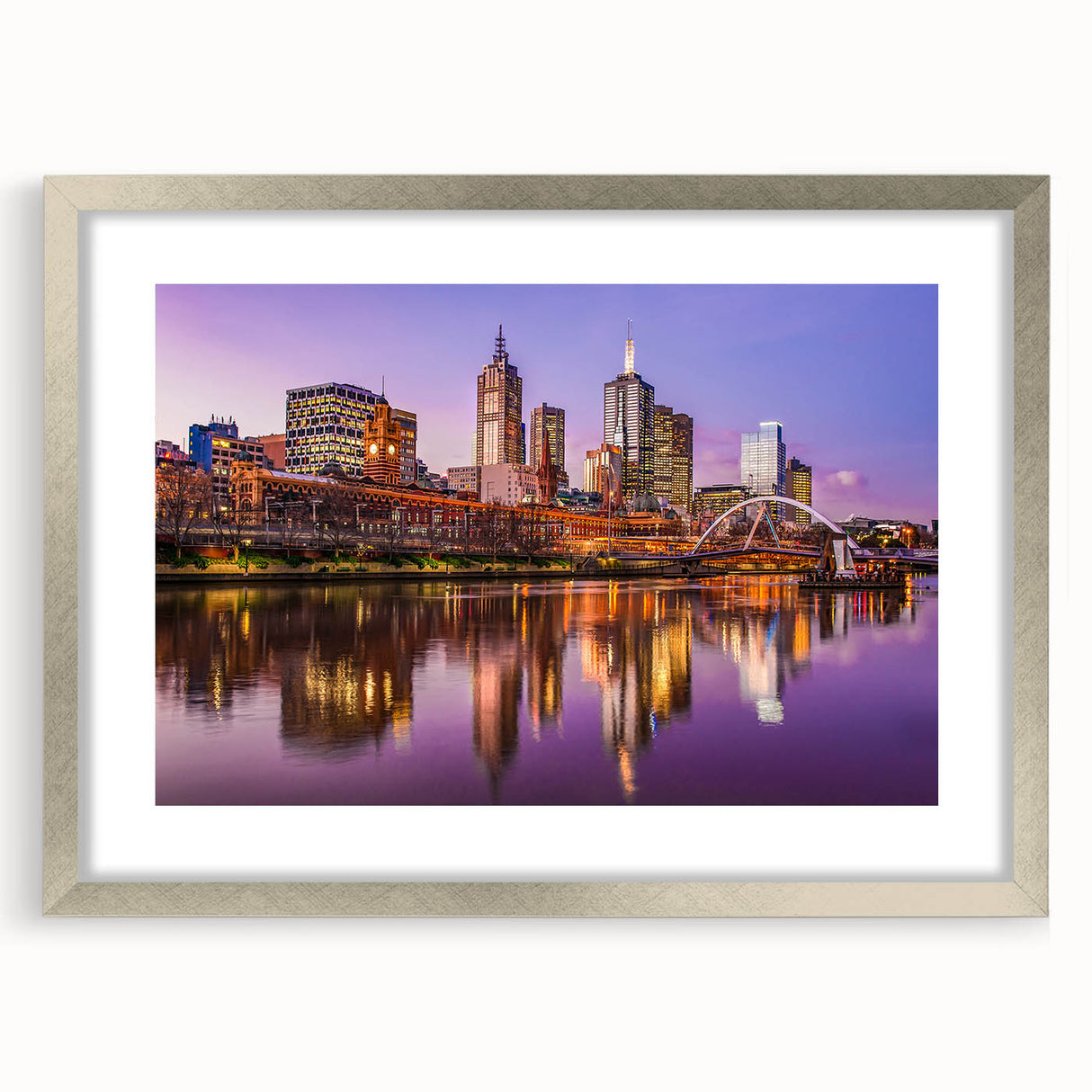 Abstract art print of Melbourne skyline in muted blue and gray tones on a framed silver mat, ideal for dining room decor.