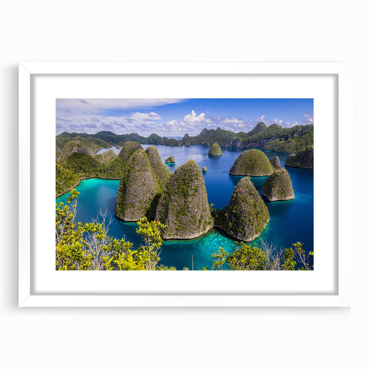 Abstract art print of an Indonesian landscape in muted earth tones on a framed white mat, suitable for dining room decor.