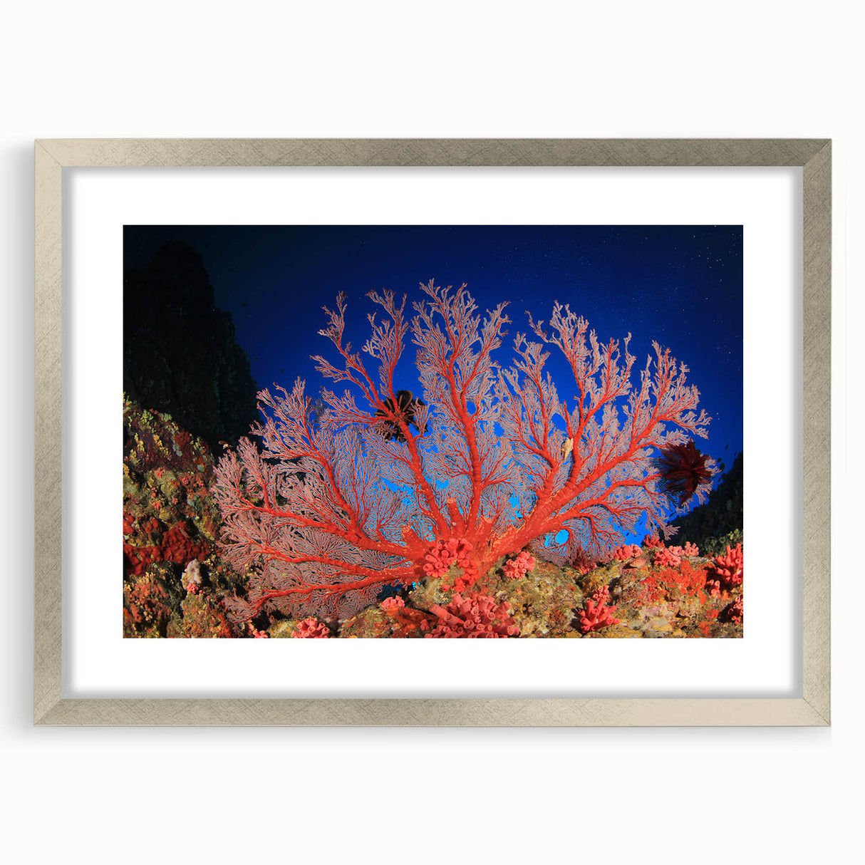 Abstract art print of the Great Barrier Reef in cool blue and green shades on a framed silver canvas.