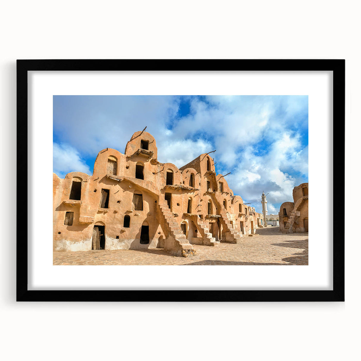 Extra large abstract art print of a colorful, textured African scenery on a black framed canvas, ideal for living room decor.