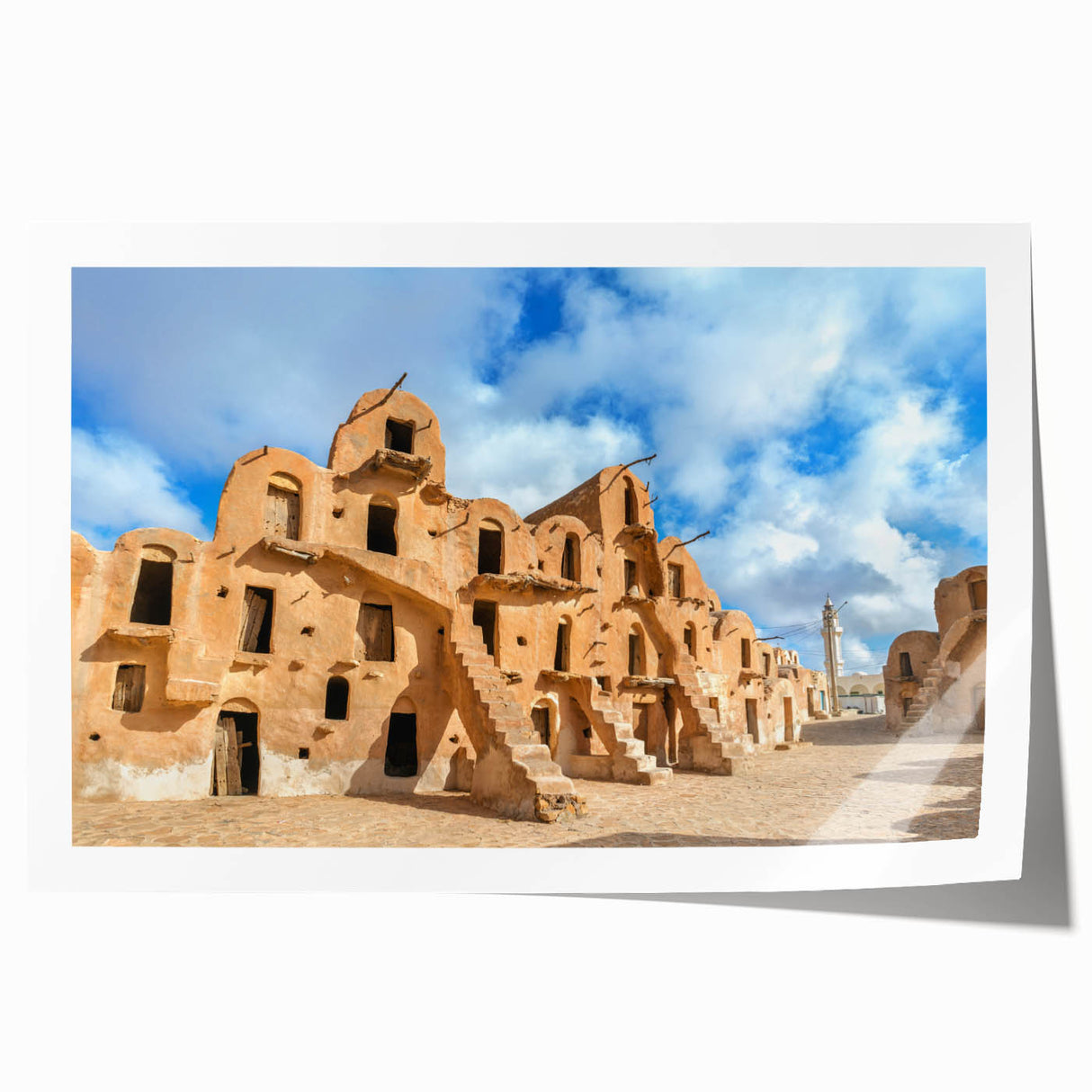 Rolled print of a Tunisian landscape with vibrant floral elements in pastel shades.