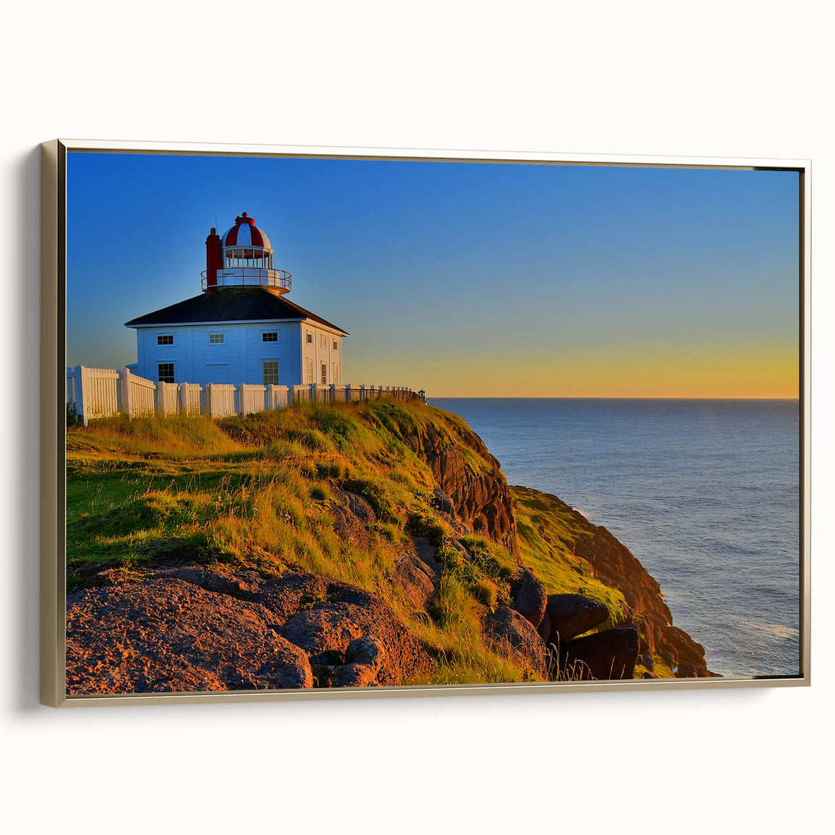 Framed canvas wall art depicting a vintage-style Newfoundland landscape in muted gold and black tones.