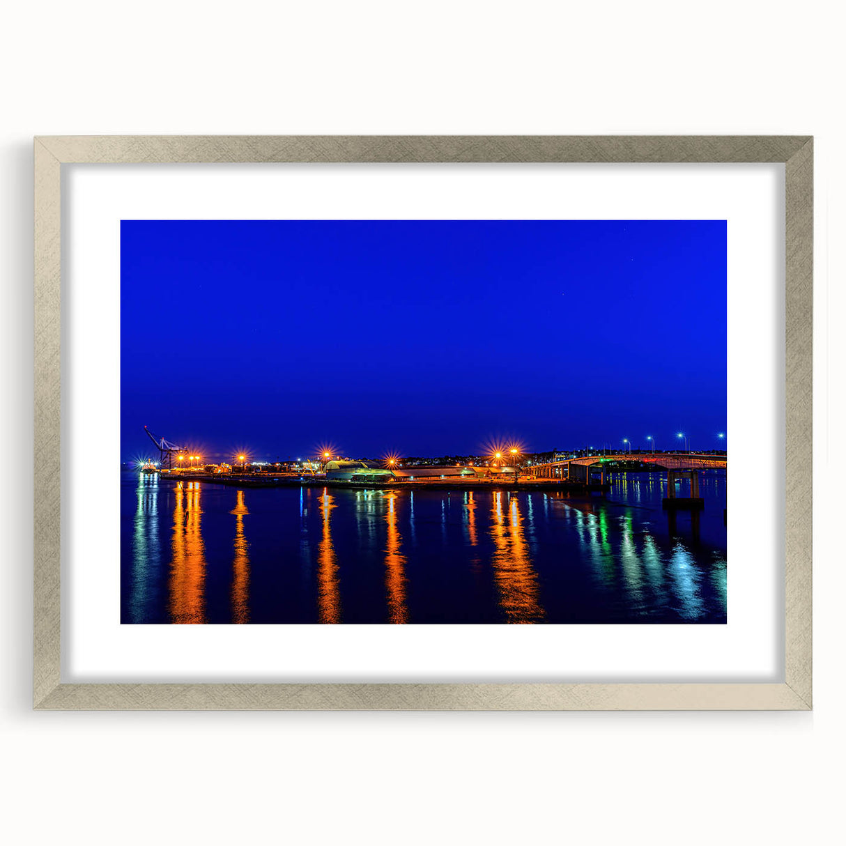 Textured art print of abstract scenery in shades of blue and gray, framed in silver, ideal for bedroom wall decor.