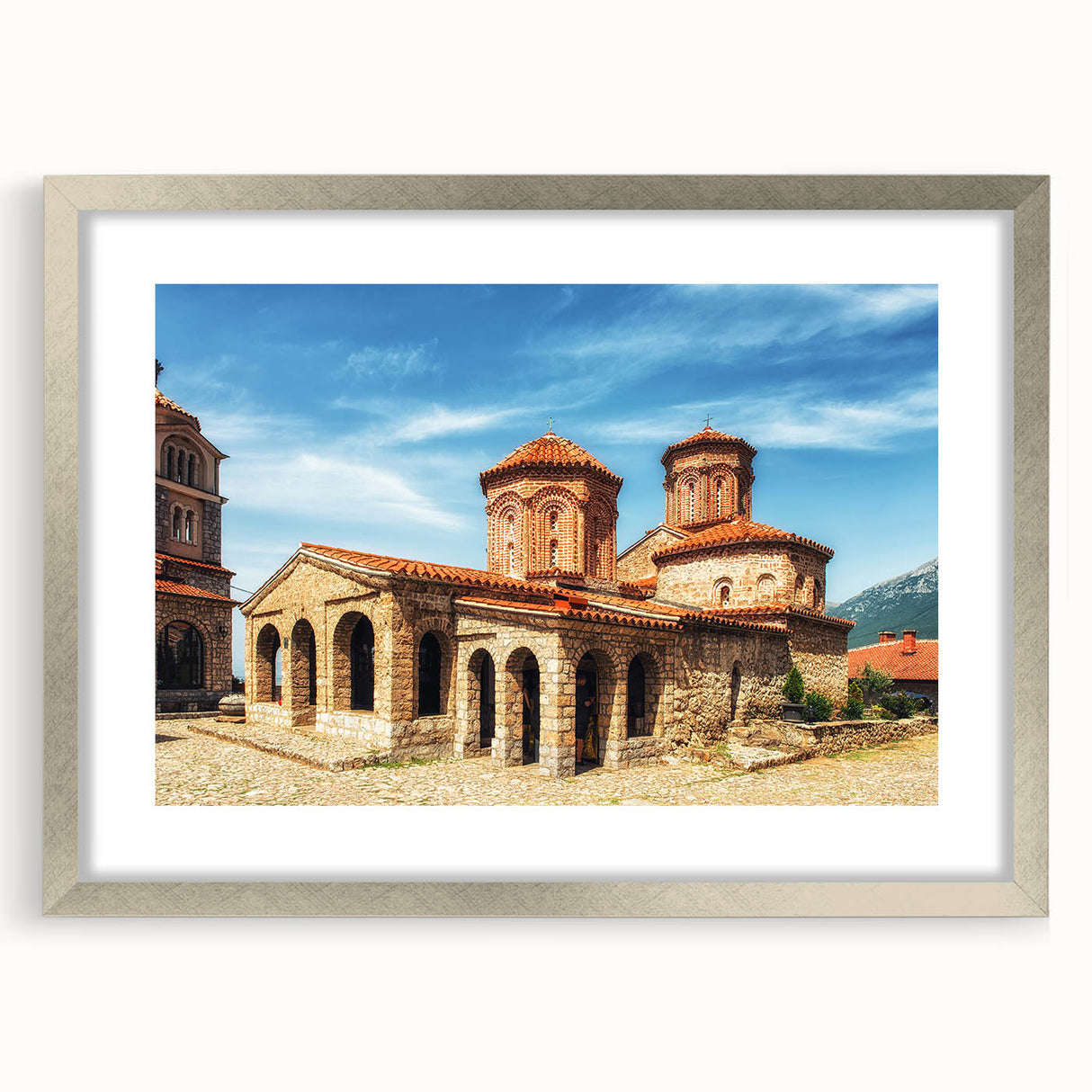 Extra large abstract art print of a textured European landscape in muted earth tones, framed in silver.