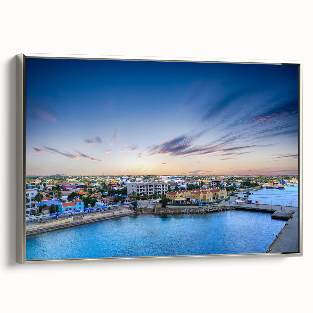 Framed canvas depicting a vibrant Caribbean landscape art painting with lush greenery and a silver frame.
