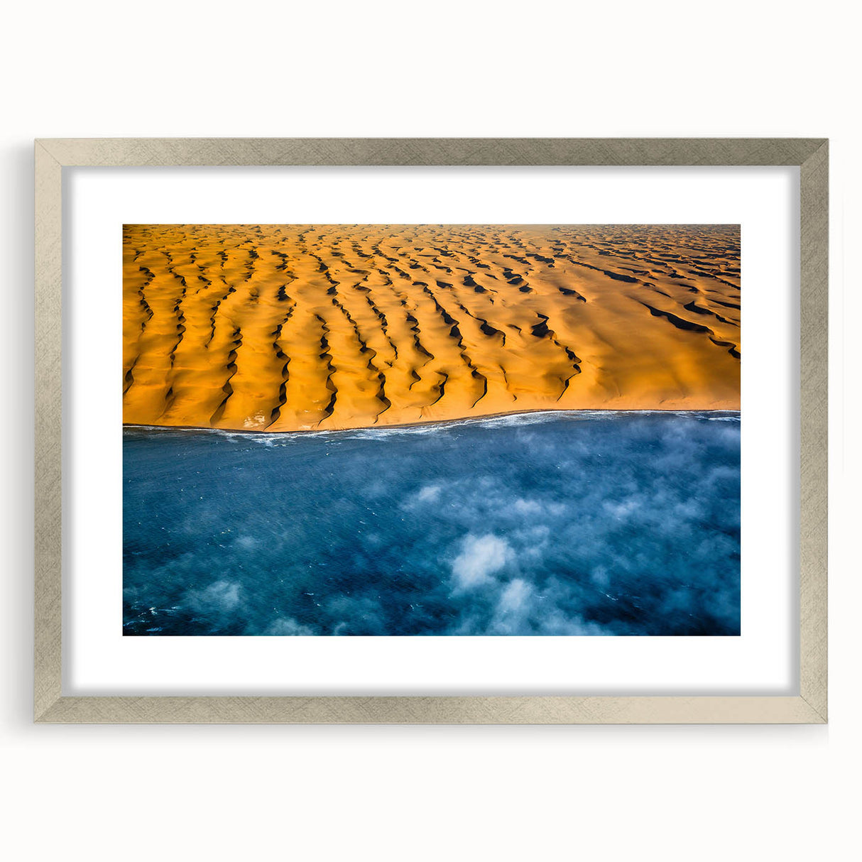 Abstract art print of a Namibian landscape in muted earth tones, framed in silver, suitable for dining room decor.