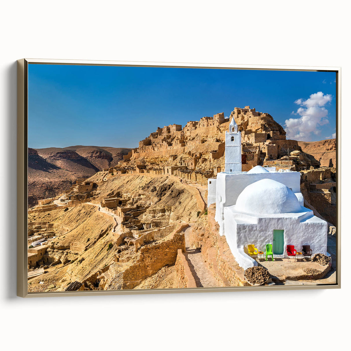 Framed canvas wall art depicting a serene Tunisian landscape in muted gold and black tones, ideal for bedroom decor.