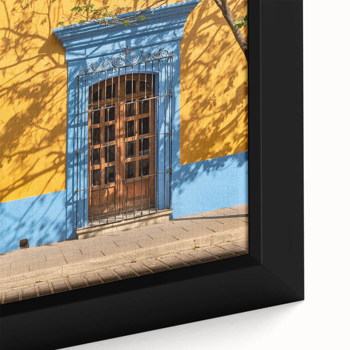 Framed canvas of a textured Mexican Oaxaca landscape in black with colorful accents, ideal for living room decor.