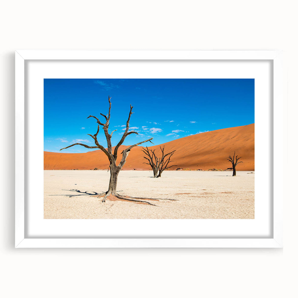 Extra large abstract art print depicting a textured Namibian landscape, with earth tones, framed in white.