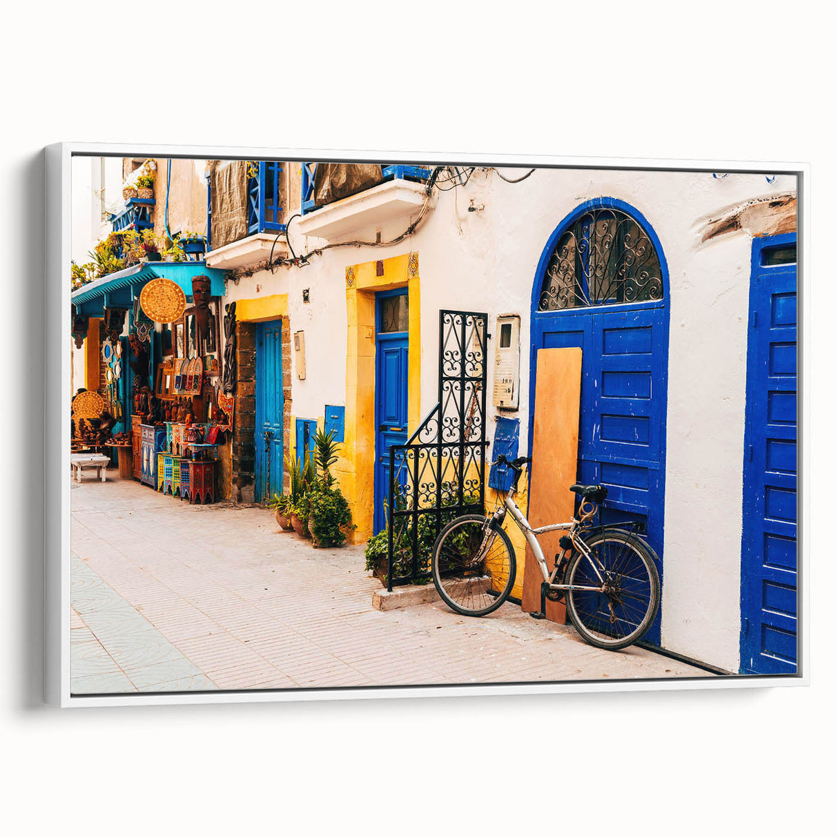 Framed canvas of a vintage Moroccan landscape in muted earth tones, suitable as wall art for a bedroom.