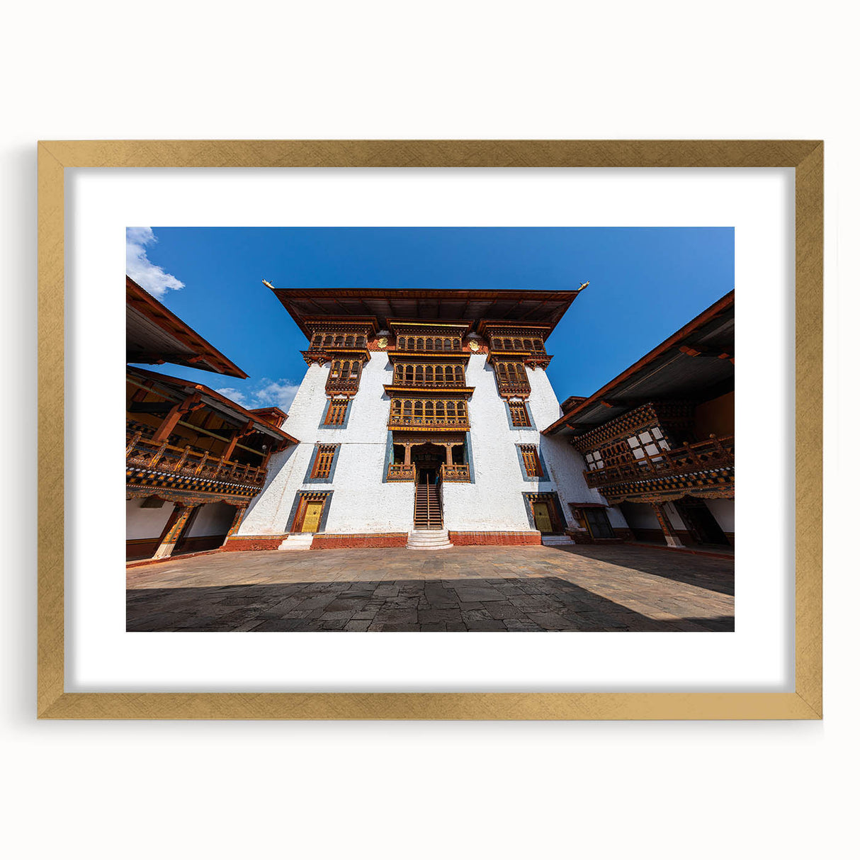 Extra large abstract art print of a Bhutanese landscape in textured gold frame, ideal for living room decor.
