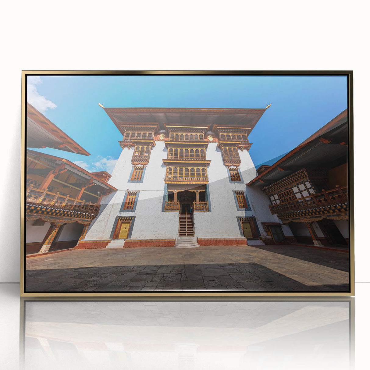 Large art print featuring a serene Bhutanese landscape in soft gold and green hues, framed acrylic.