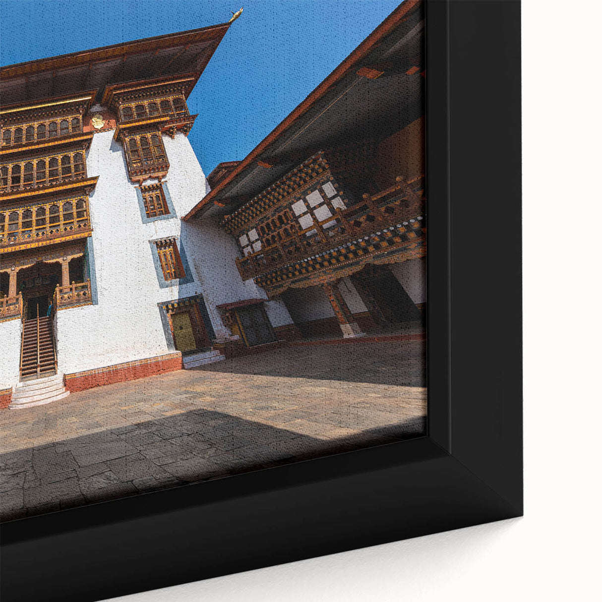 Extra large black wall art featuring a textured, colorful Bhutanese landscape on framed canvas.