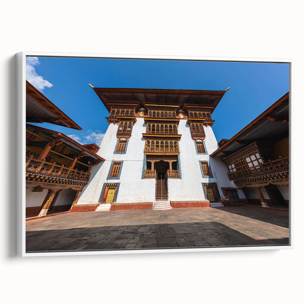 Extra large framed canvas of vintage poster art depicting a scenic Bhutan landscape in colorful tones.