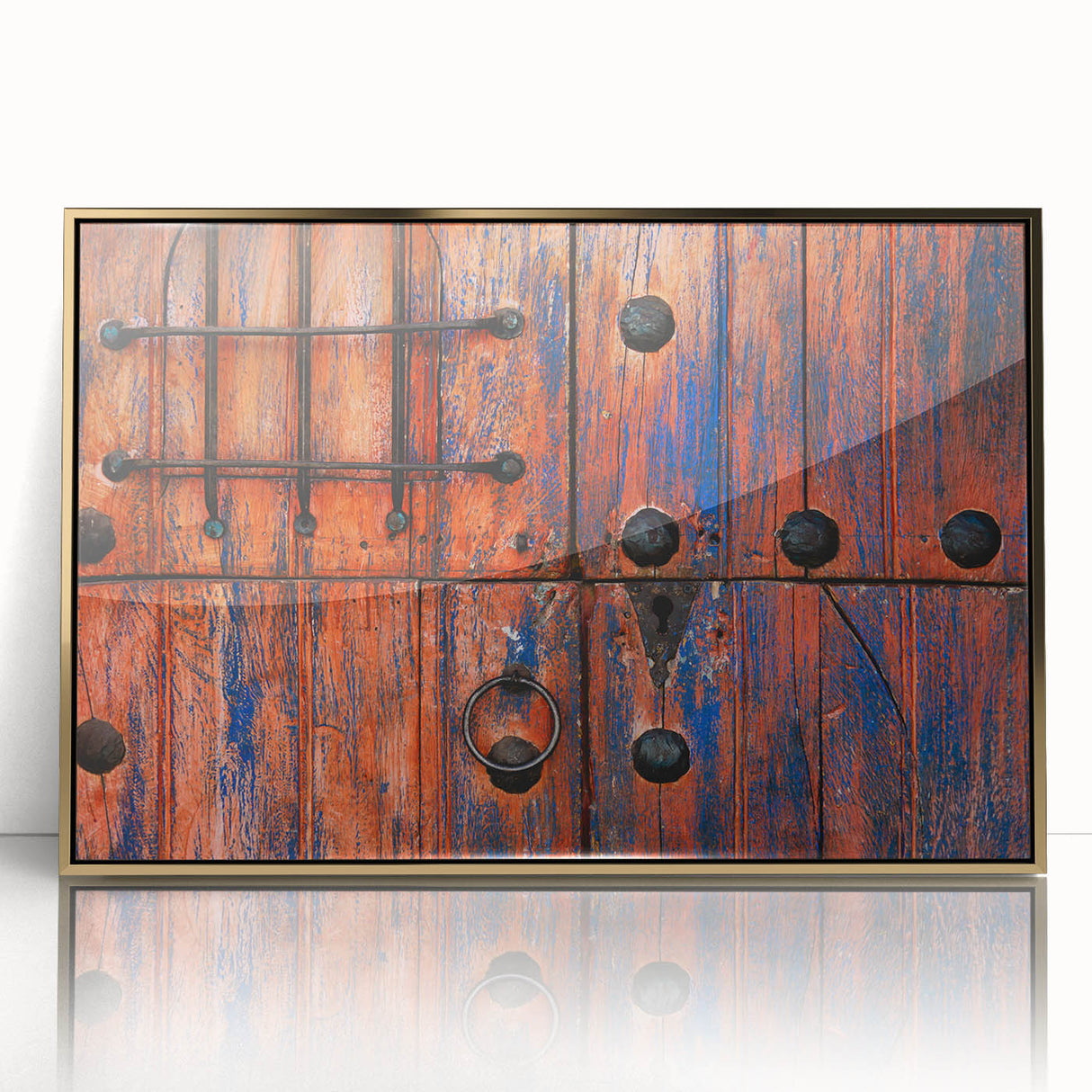 Large art print of Baja California scenery in gold frame, featuring mid-century modernist style.