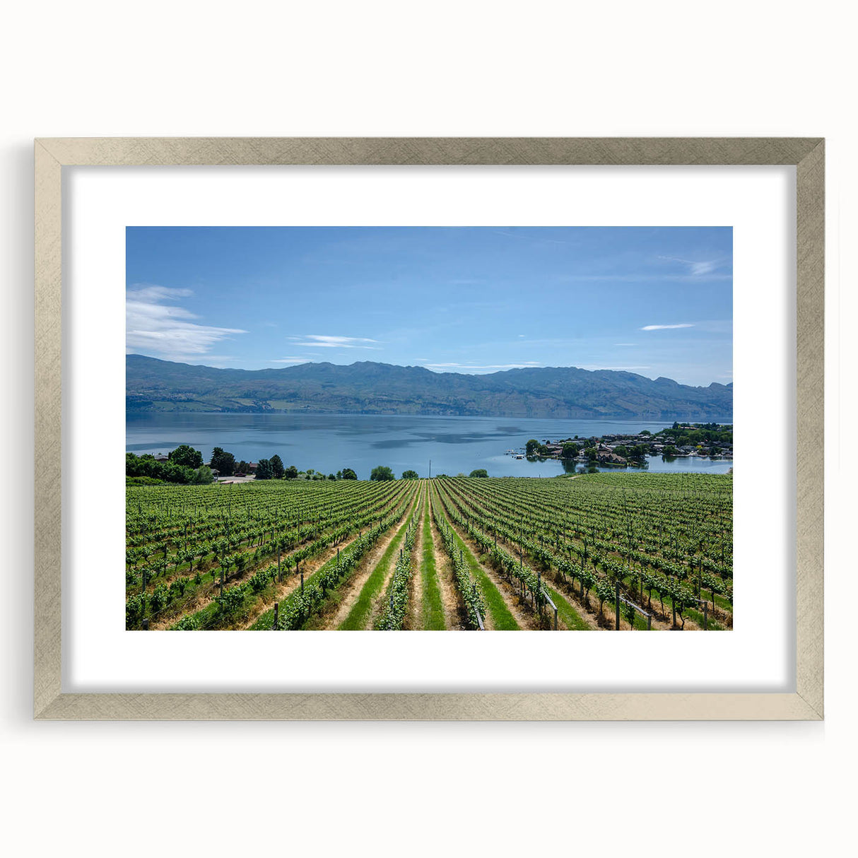 Textured art of abstract British Columbia scenery in muted earth tones on a framed silver mat, ideal for bedroom decor.