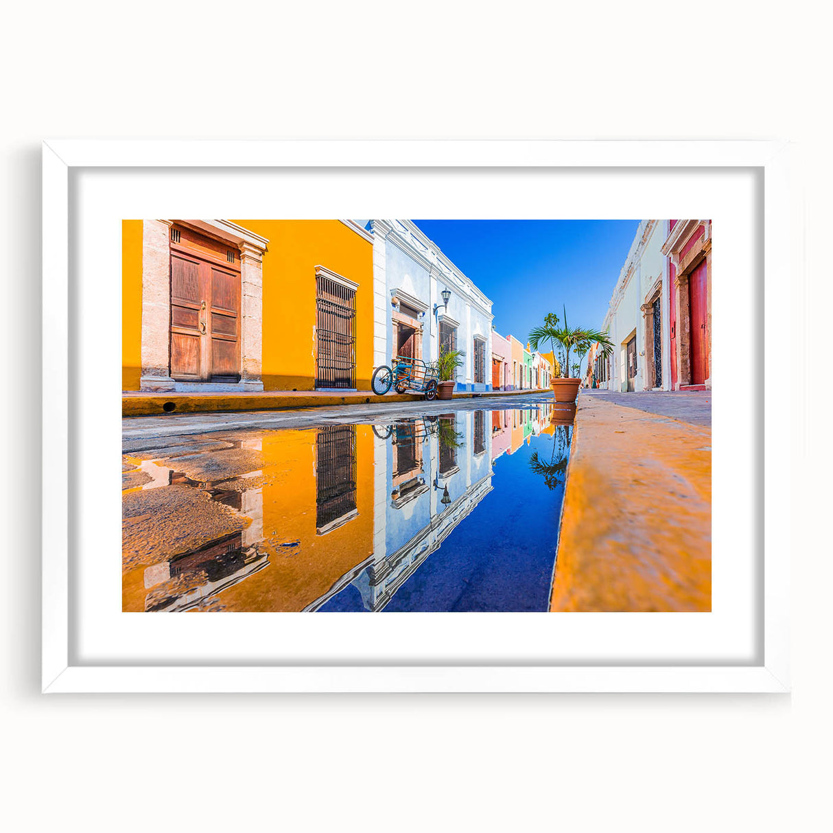 Abstract art print depicting a stylized Yucatan scenery in muted earth tones, framed with a white mat.