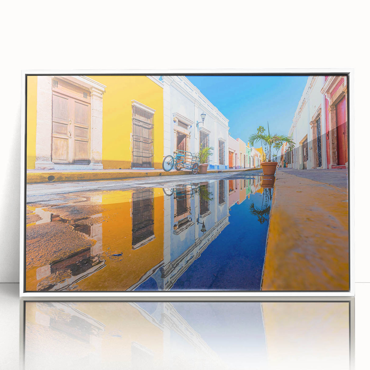 Acrylic print of a Yucatan scenery with bright blues and greens, framed in white.