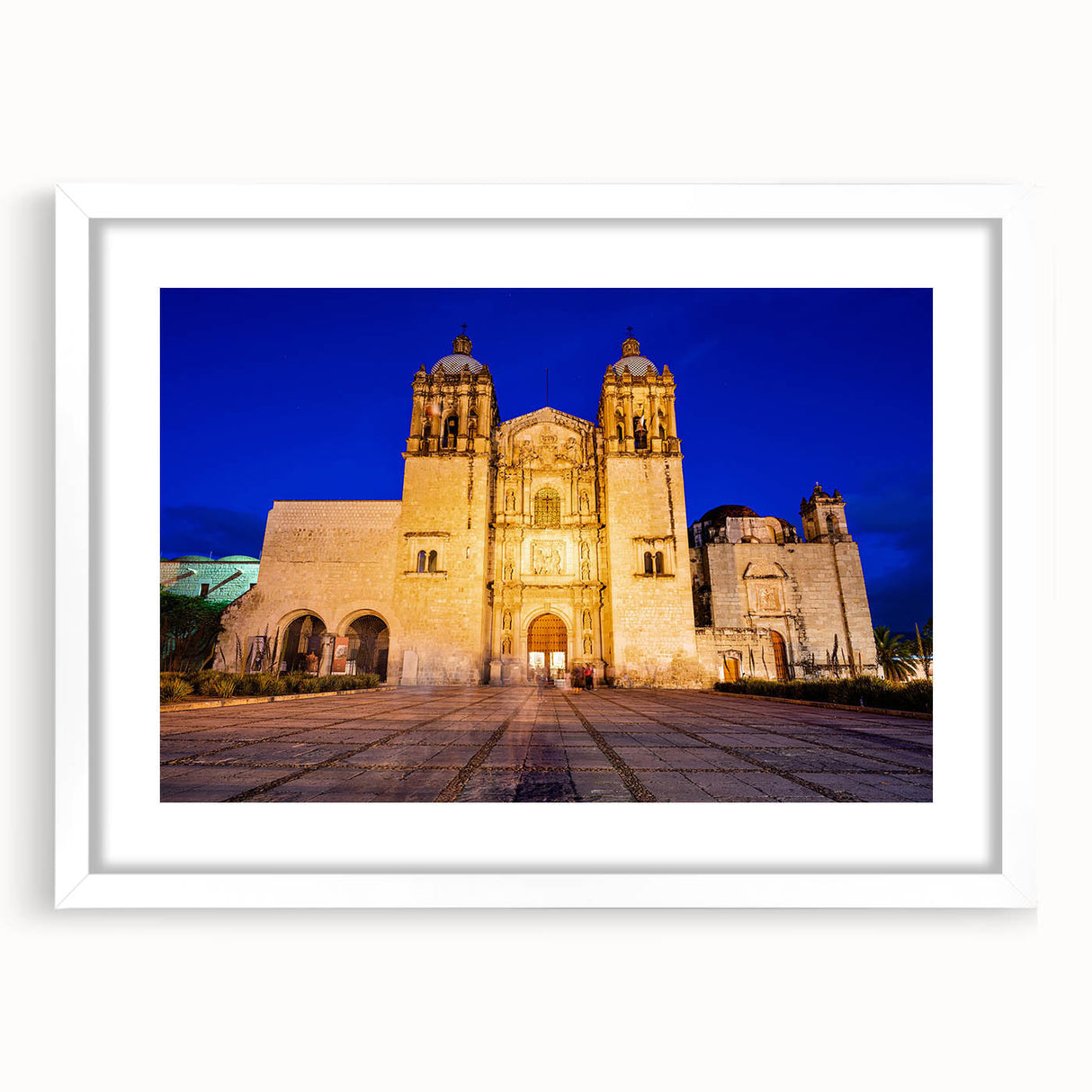 Abstract art print depicting a colorful Oaxaca scenery in a white framed mat, ideal for dining room decor.