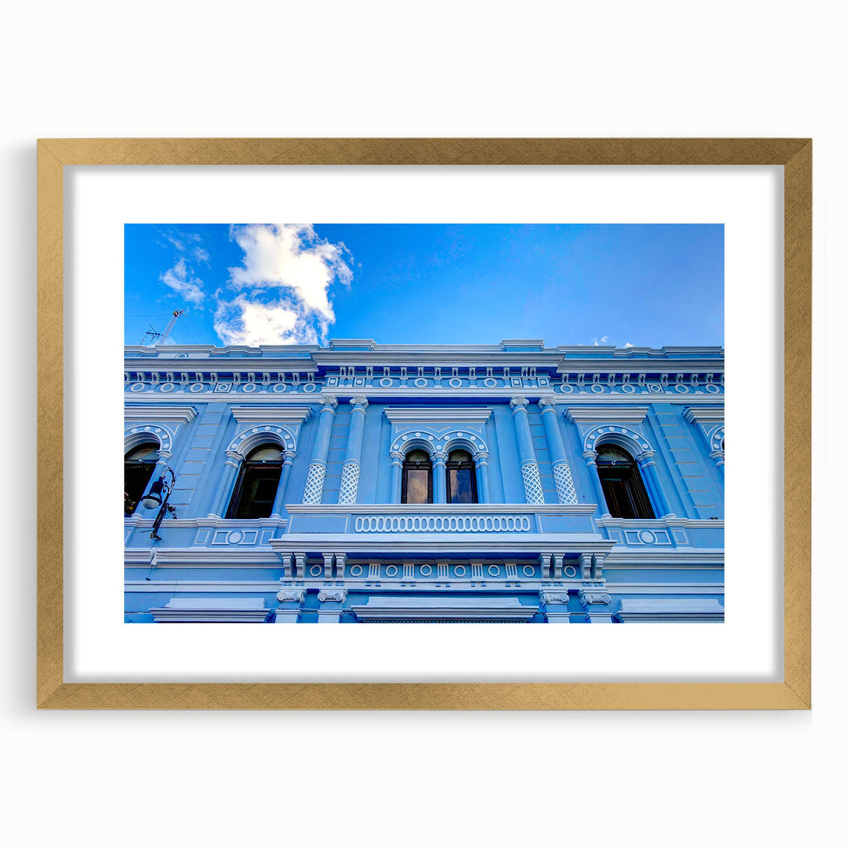 Extra large abstract art print featuring textured scenery of Yucatan in muted earth tones, framed in gold.