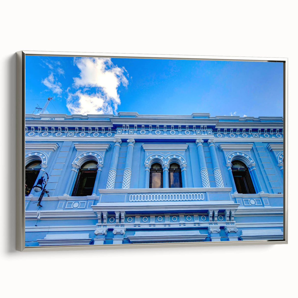 Landscape painting of Yucatán scenery on a silver-framed canvas, featuring vibrant, colorful art and vintage poster style.