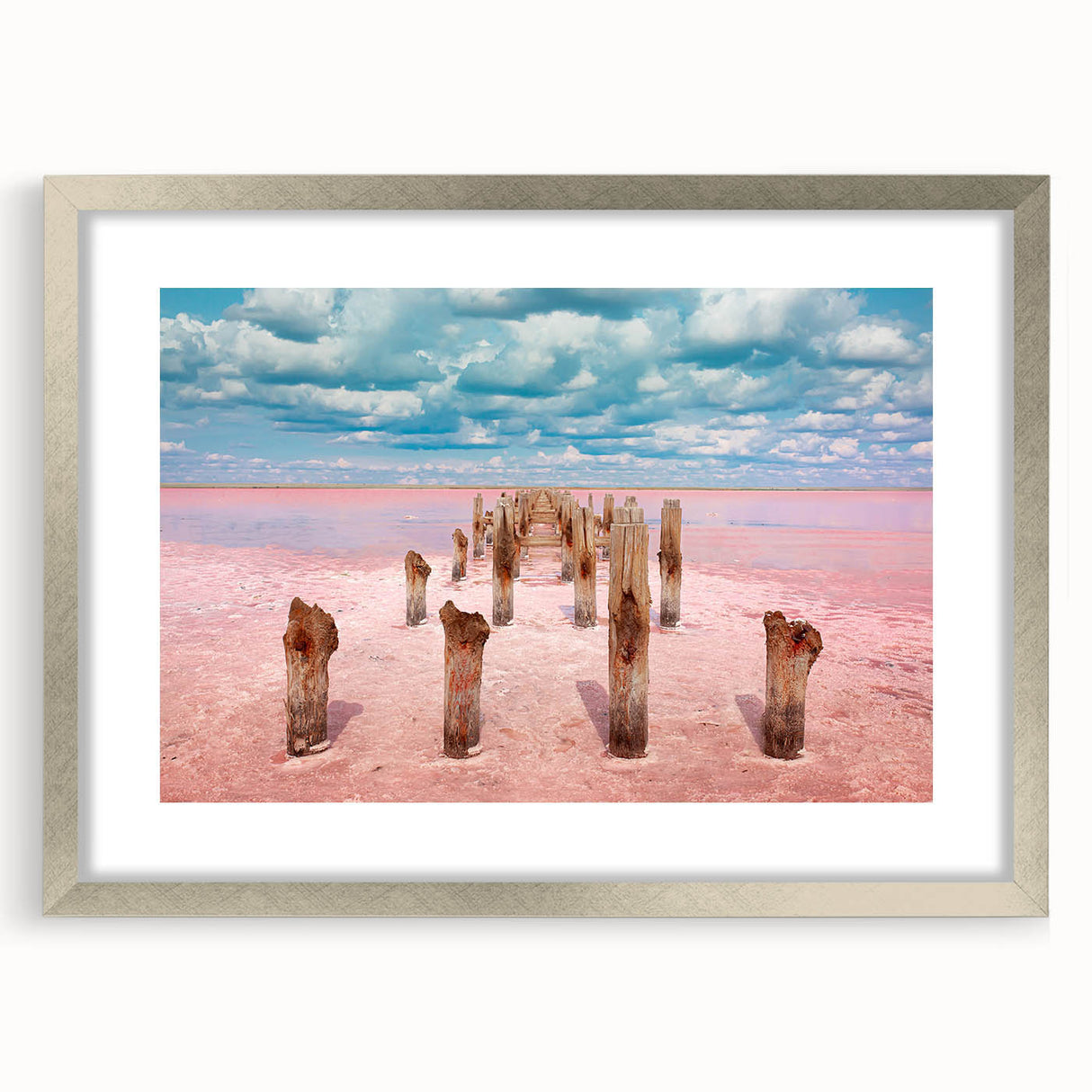Textured abstract art print depicting Yucatan scenery in muted earth tones, framed in silver, suitable for bedroom decor.
