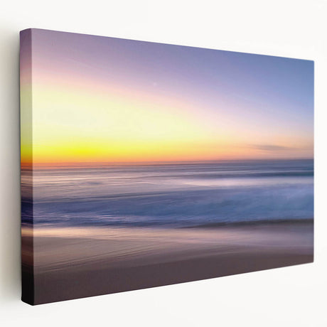 Stretched canvas artwork depicting a serene beach landscape with soft pastel colors, showcasing gentle waves and a tranquil sky, ideal for home decor.