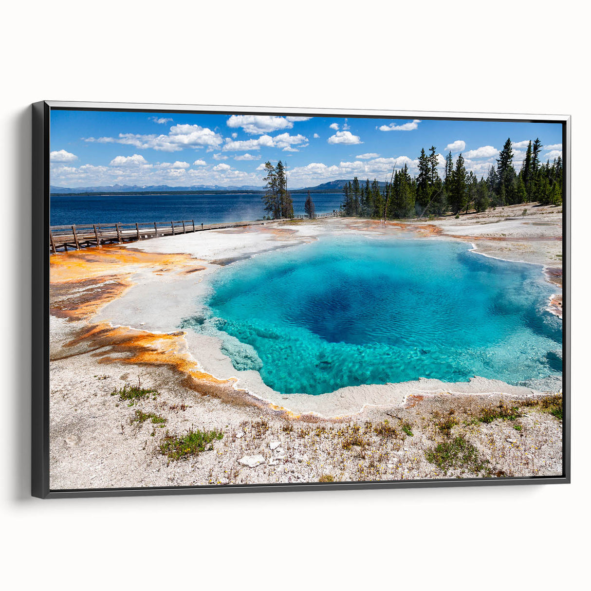 Framed canvas wall art showcasing a striking geyser landscape design, featuring vibrant colors and intricate details, displayed from a black side view for modern decor.