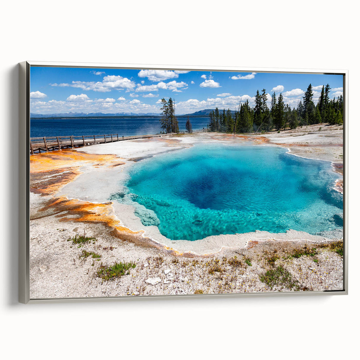 Framed canvas wall art featuring a serene landscape with a geyser design, elegantly bordered in silver, perfect for modern home decor. Enhances living spaces with nature-inspired aesthetics.
