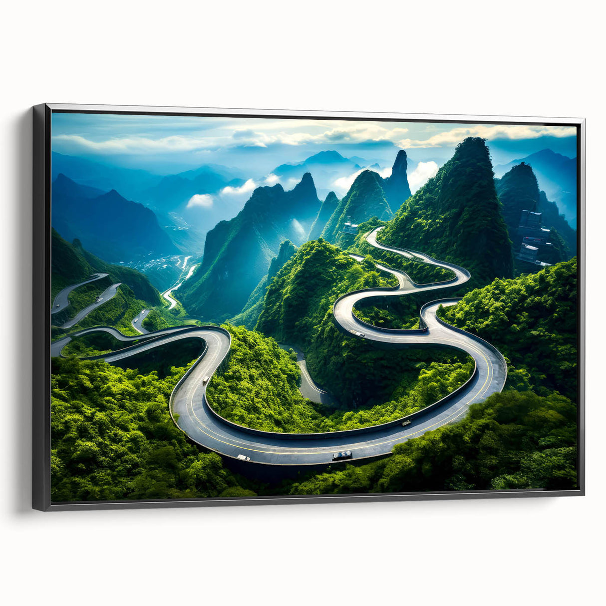 Framed canvas wall art showcasing a scenic landscape with winding roads and lush greenery, displayed in black frame for a modern aesthetic.