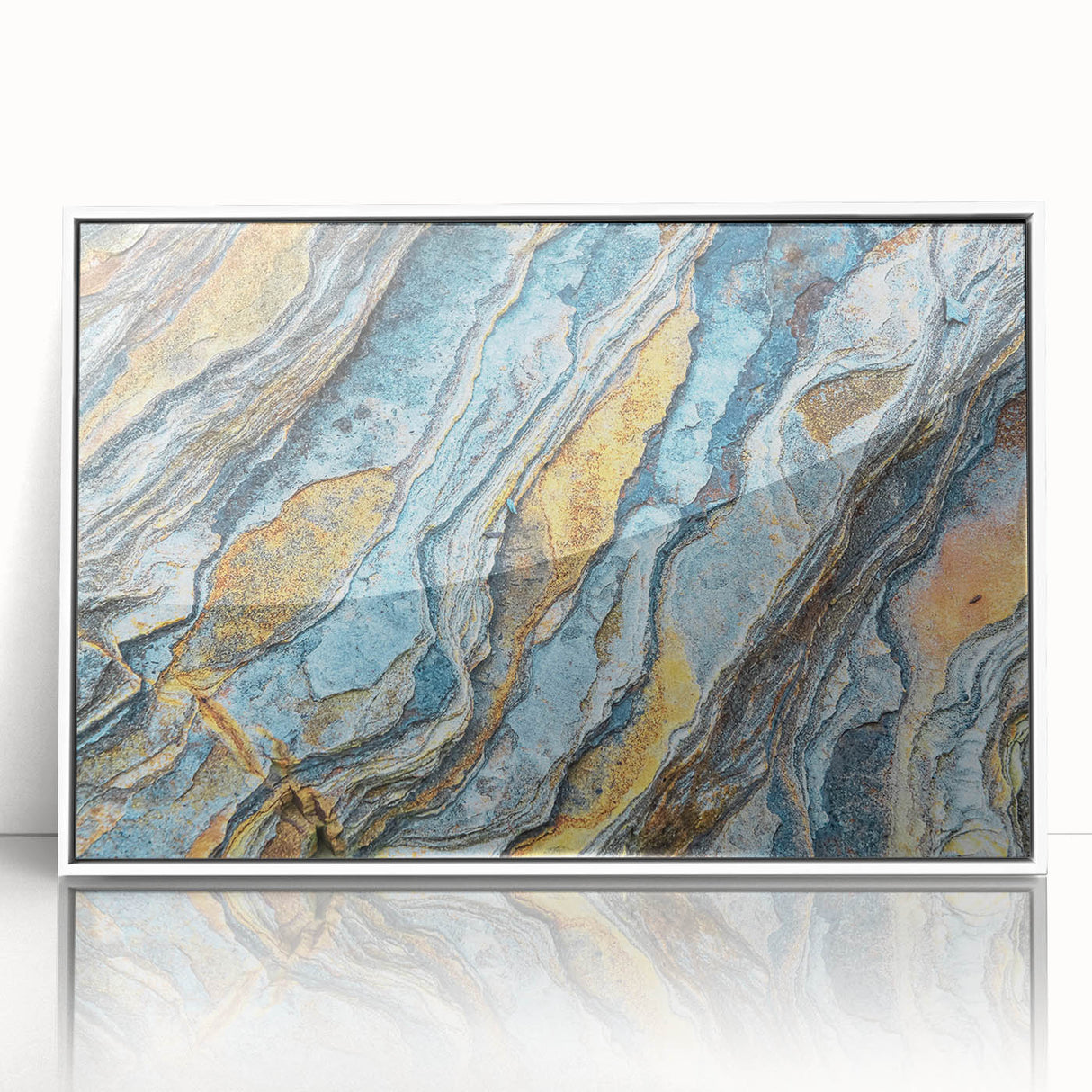 Framed acrylic wall art featuring a serene landscape with rocks and soft hues, displayed in a sleek white frame, enhancing modern decor aesthetics.