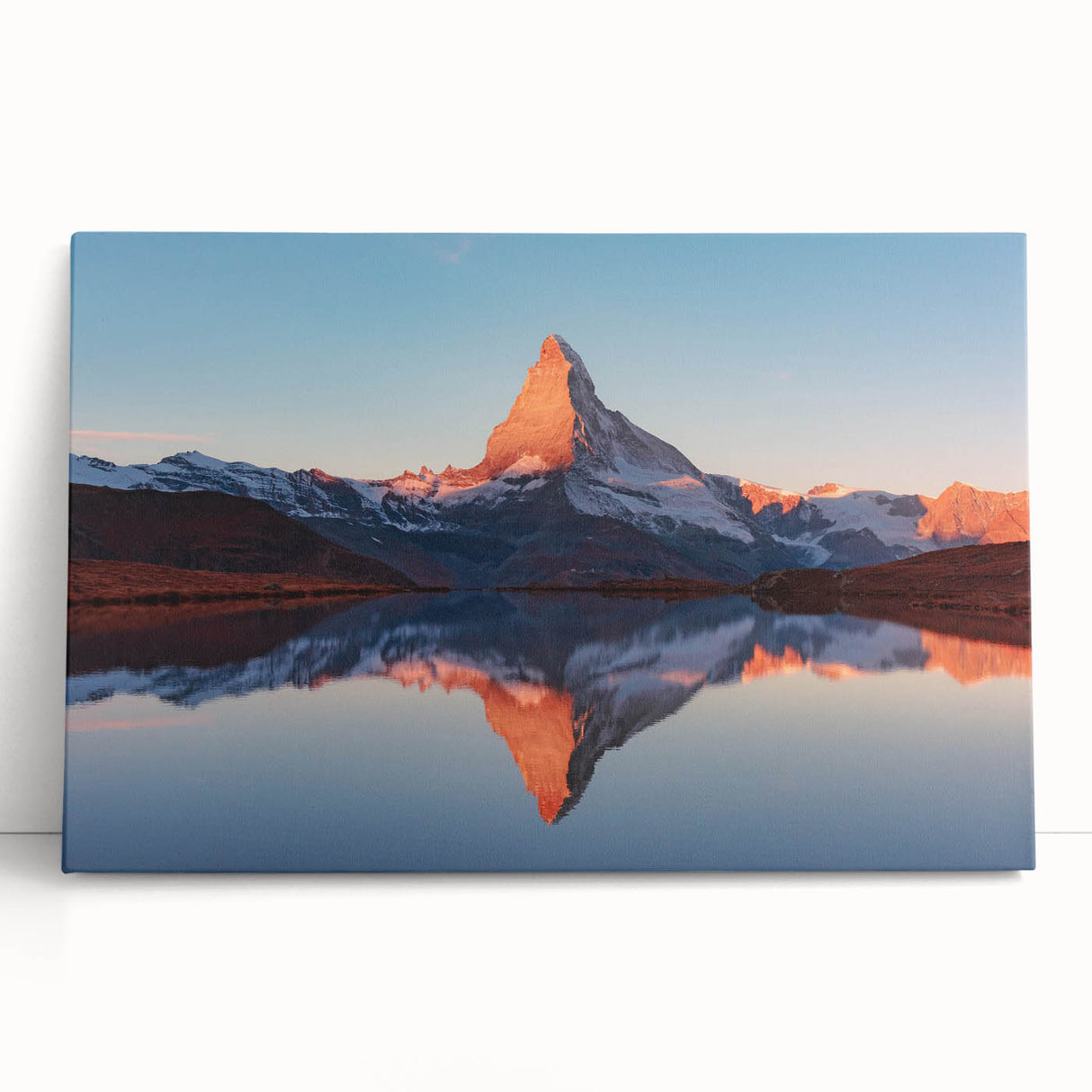 Stretched canvas artwork showcasing an abstract landscape with vibrant colors and textured rocks, elegantly leaning against a wall in a modern interior setting.