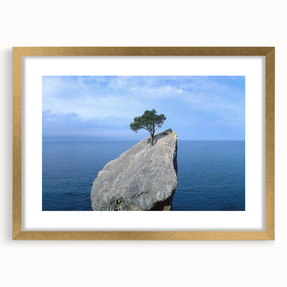 Framed wall art featuring a stunning landscape design with rocks, highlighted by a gold mat and frame, perfect for enhancing modern home decor.