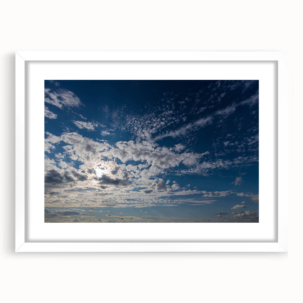 Framed landscape wall art collection featuring serene skyscapes in soft pastel colors, displayed with a white mat for an elegant finish, enhancing modern decor.