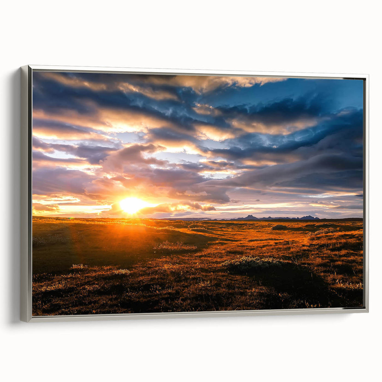 Framed canvas wall art collection showcasing a serene landscape with vibrant colors, elegantly displayed in a silver frame, ideal for modern home decor.